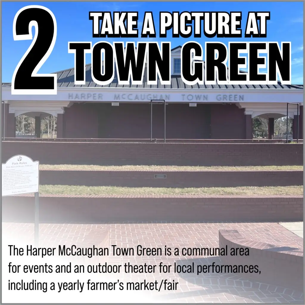 Take a picture at Harper McCaughan Town Green, featuring event signage and outdoor theater space for local performances and community activities.