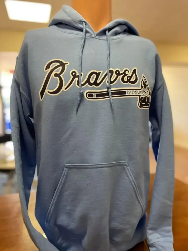 Custom blue sweatshirt featuring "Braves" logo and axe design, showcasing personalized apparel for branding at corporate events.
