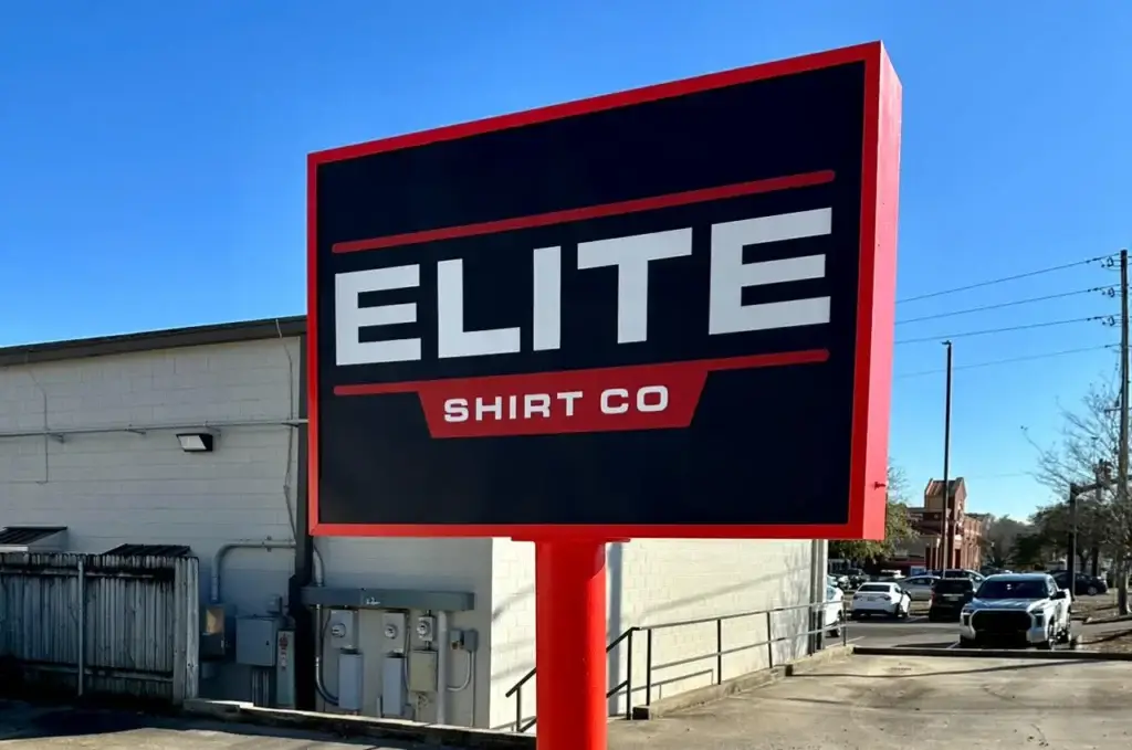 Elite Shirt Co. storefront sign showcasing the company name prominently, emphasizing custom apparel and promotional products.